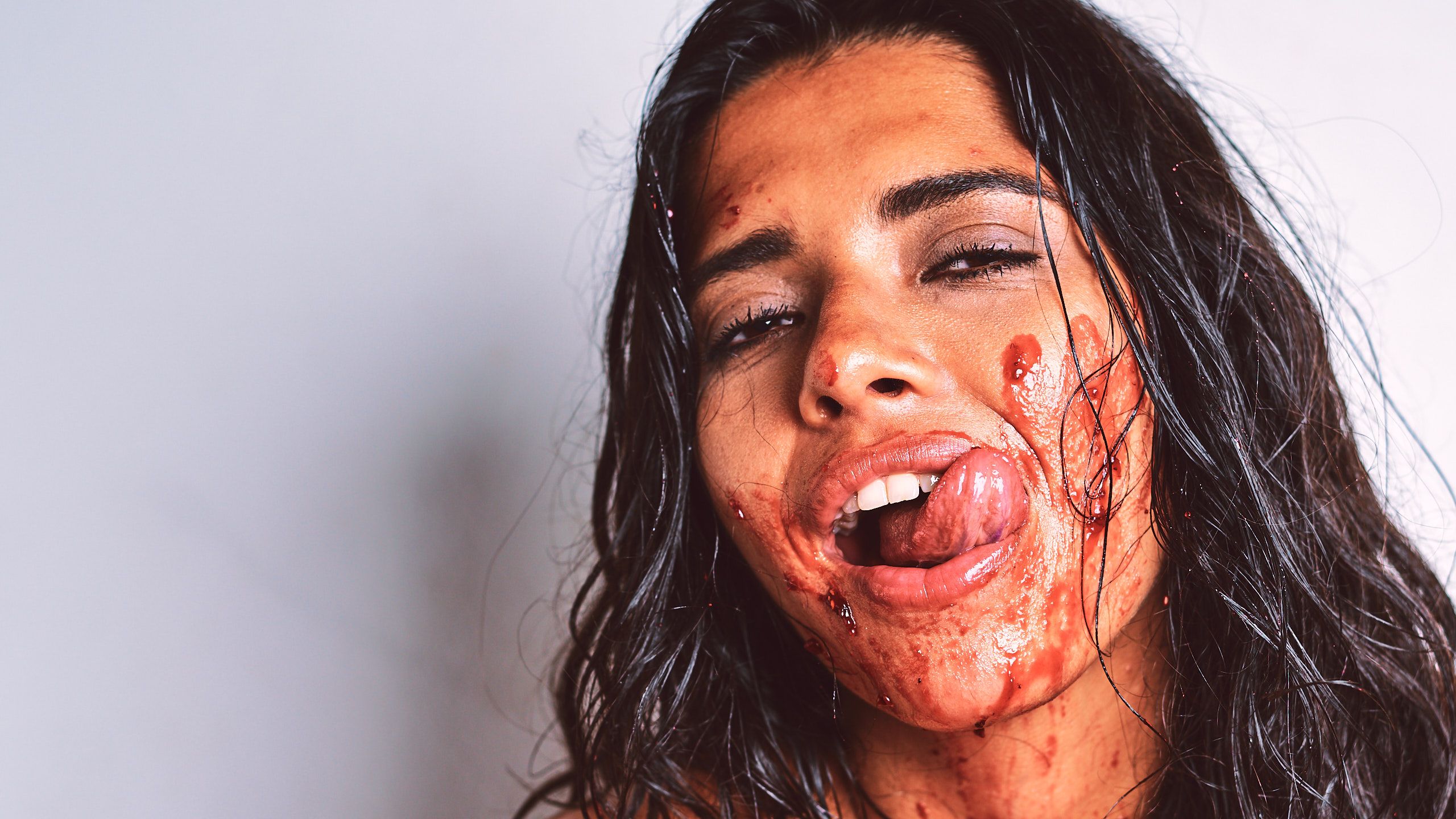 African Beauty nude with a long braid, smearing white cream across her tattooed dark skin and intimate areas