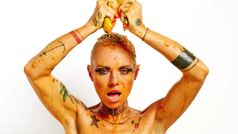 Lu Epic in a fully nude erotic series with papaya fruit smeared on skin and face