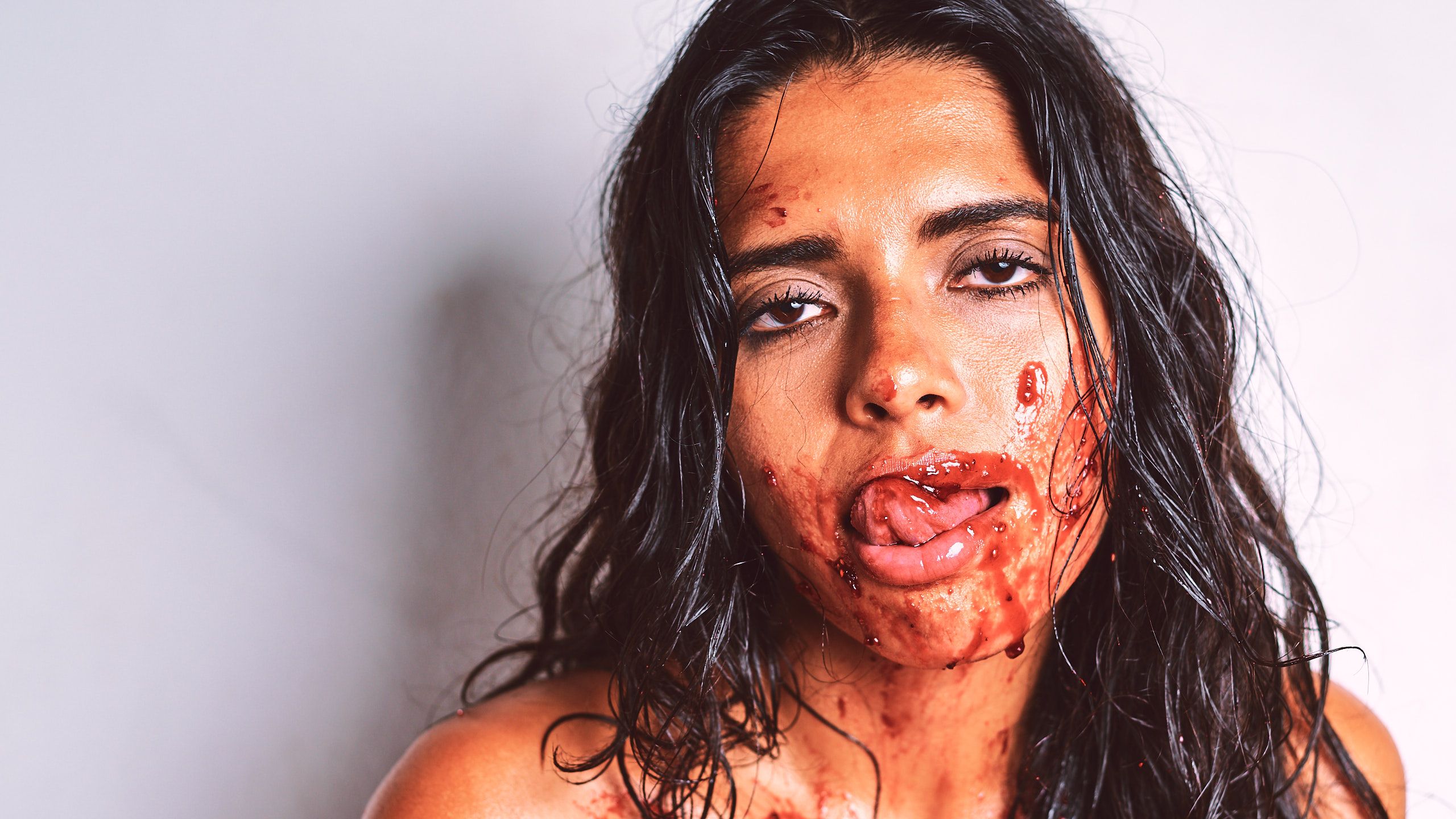 African Beauty nude with a long braid, smearing white cream across her tattooed dark skin and intimate areas