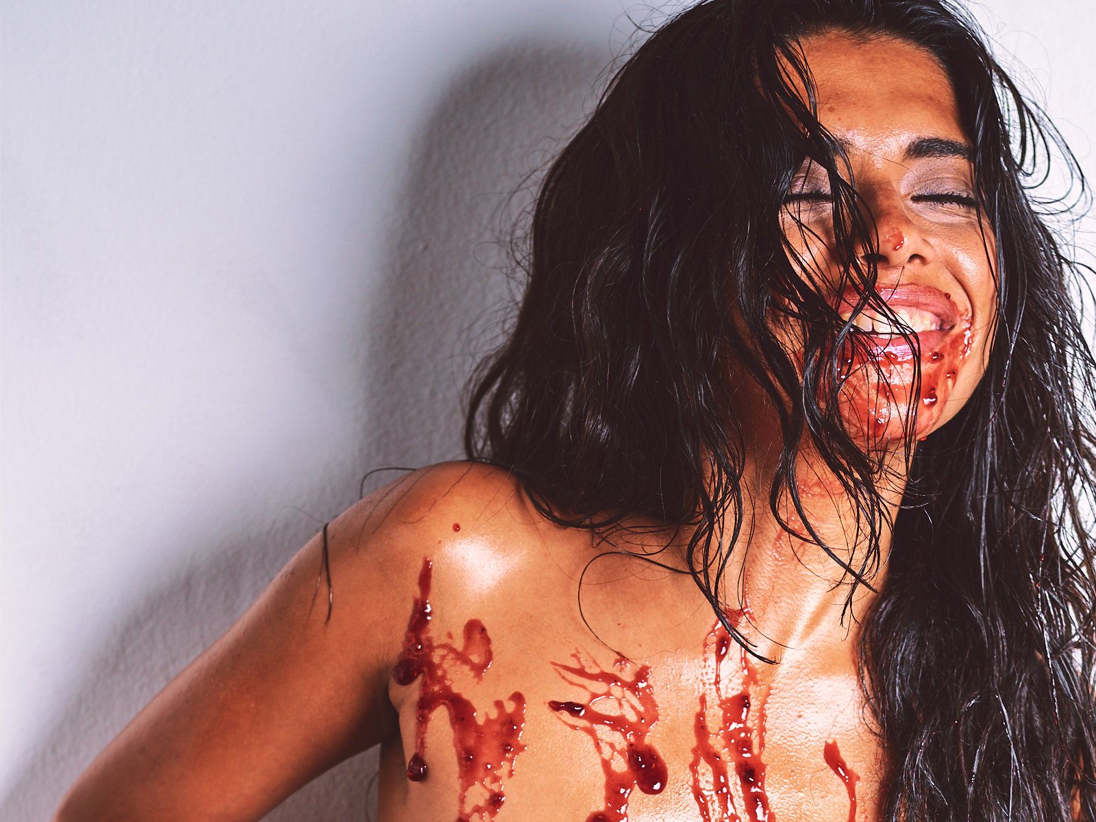 African Beauty nude with a long braid, smearing white cream across her tattooed dark skin and intimate areas