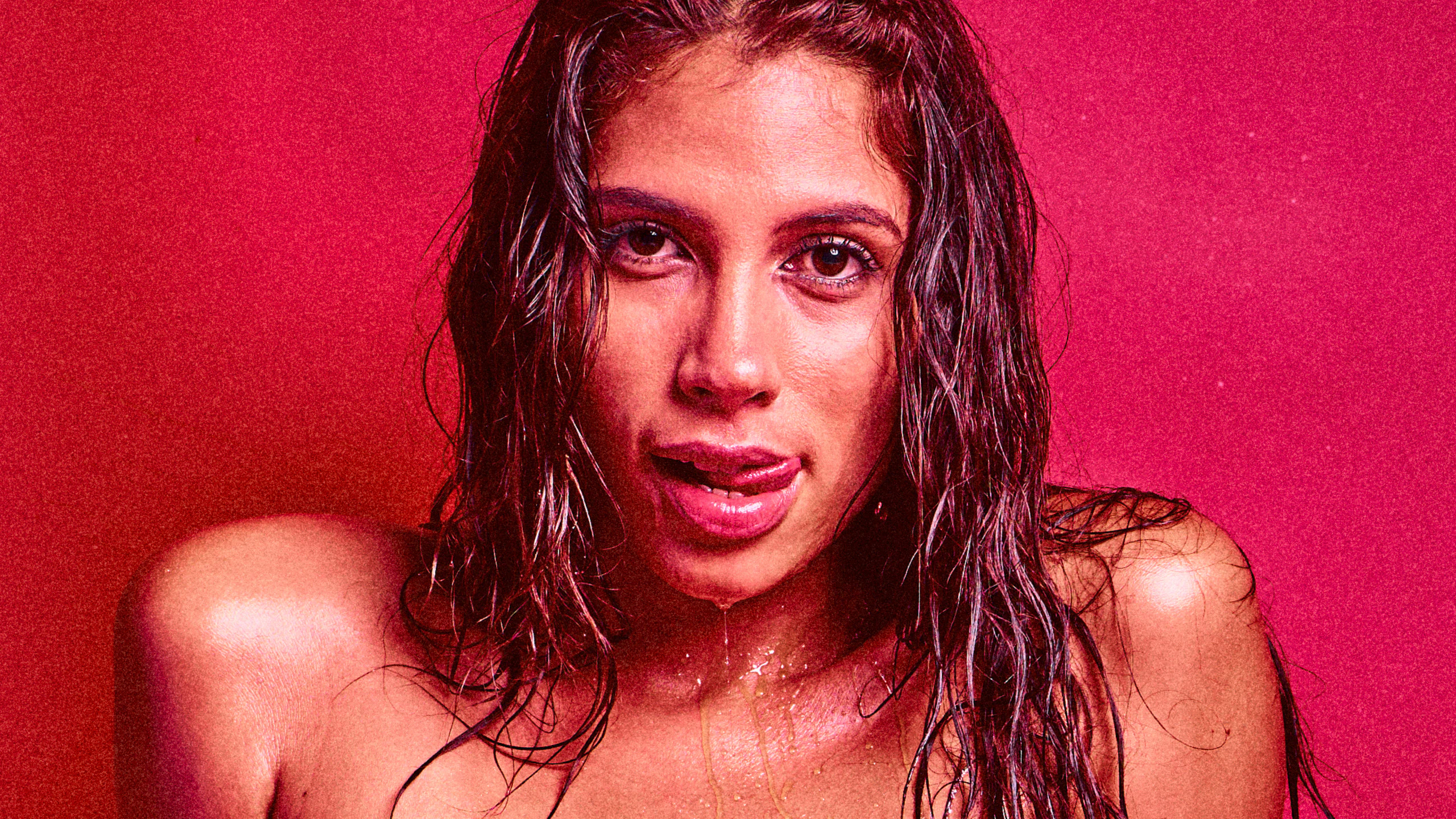 Venezuelan model Baby Nicols nude, body dripping wet in an erotic red studio setting