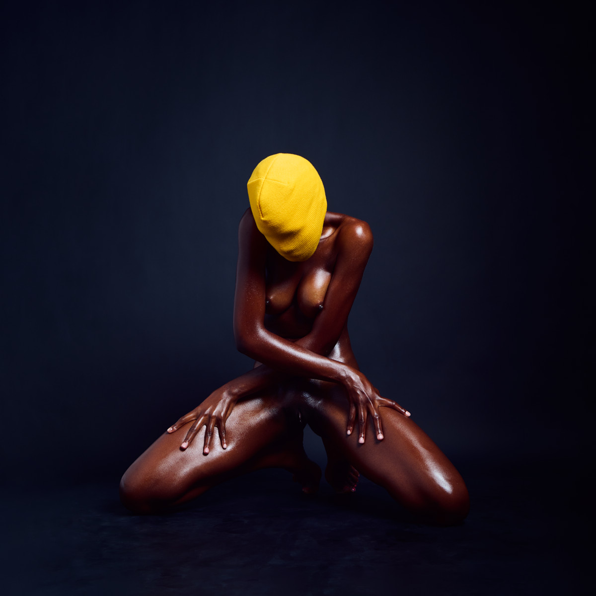 Anonymous erotic art portrait with yellow beanie and dark skin