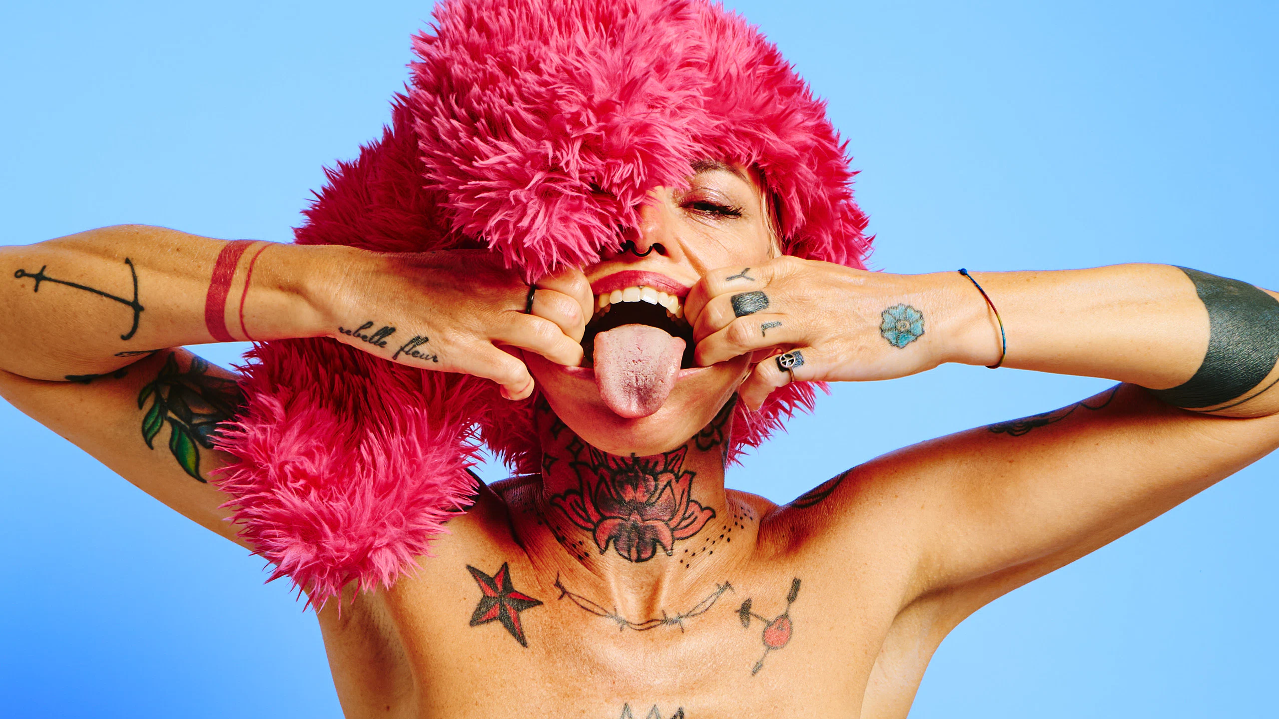 Explicit art portrait of a tattooed model in Red Rabbit, blue boots and dramatic styling