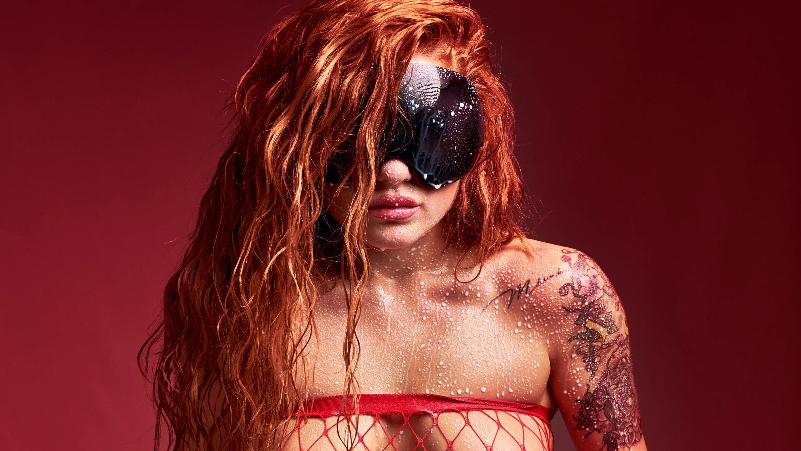 Red-haired model Red Yuliya in provocative poses with net stockings and milk drops on her skin from the Netted Temptation series.