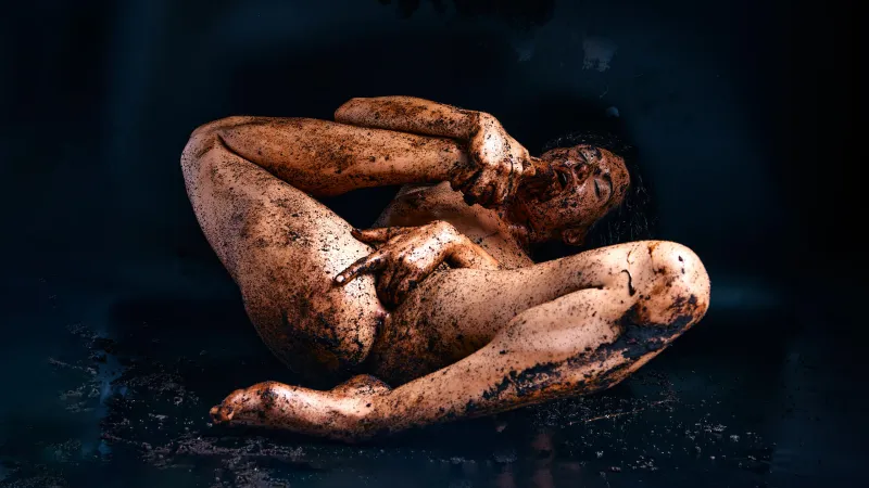 Gia Ren covered in dirt, posing provocatively with a messy, earthy aesthetic in the Dirty series, highlighting her body, expression, and tactile textures.
